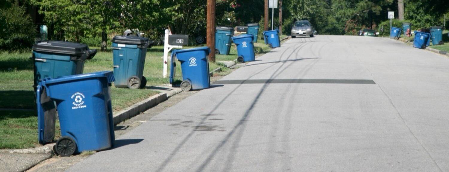 Recycling carts along a residential curb early in the morning